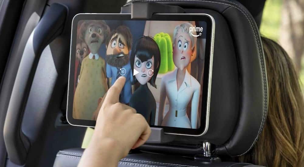 A child is shown watching a movie in the rear passenger seating area of a 2025 Ford Expedition.
