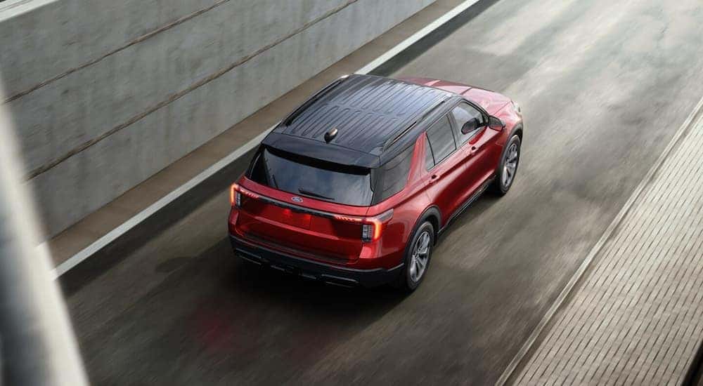 A red 2025 Ford Explorer for sale near Milford on a test drive.