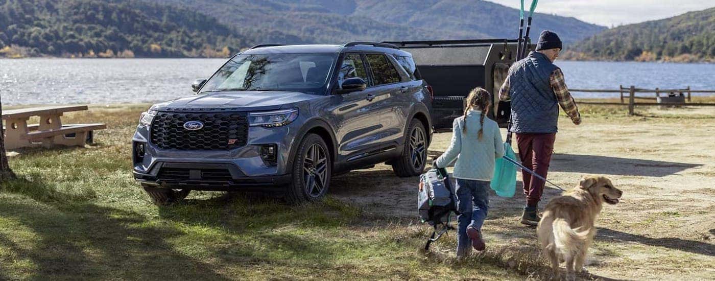 Blue 2025 Ford Explorer ST parked at a campsite.