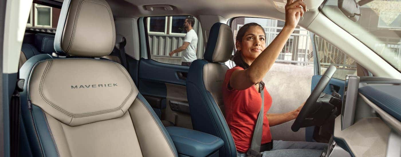 Woman test driving a 2025 Ford Maverick Lariat at a Ford dealer near Springdale.