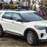 A white 2025 Ford Explorer parked near a family.