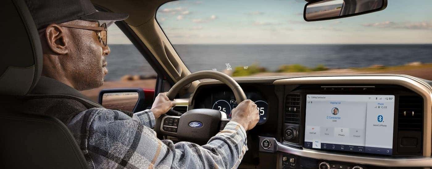 The tan interior of a 2025 Ford F-150 from the rear seats.