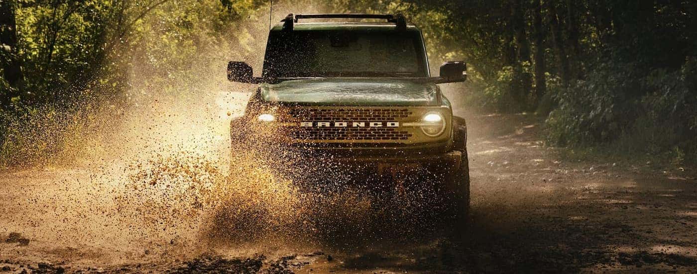 A green 2025 Ford Bronco off-roading.