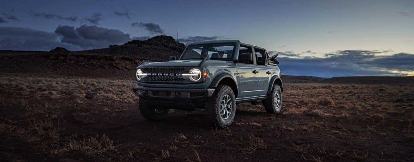 Grey 2024 Ford Bronco Badlands parked on a prairie.