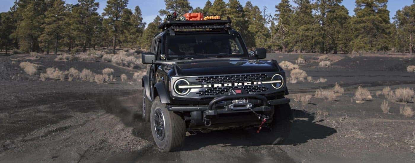 A black 2025 Ford Bronco off-roading on sand