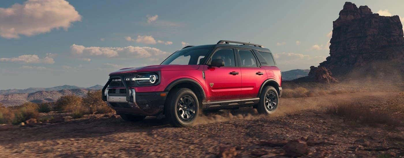 An off-roading red 2025 Ford Bronco Sport for sale near Hyde Park.