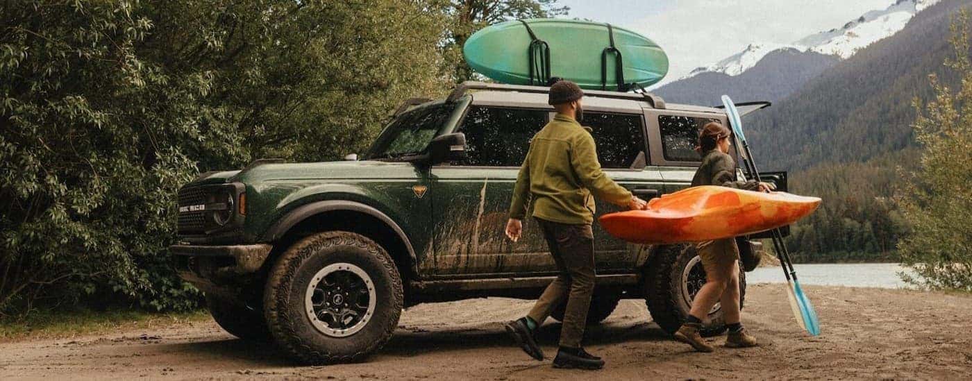 A green 2025 Ford Bronco Badlands parked off-road.