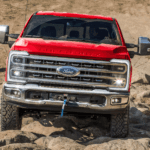 Red 2026 Ford F-250 Super Duty driving off road
