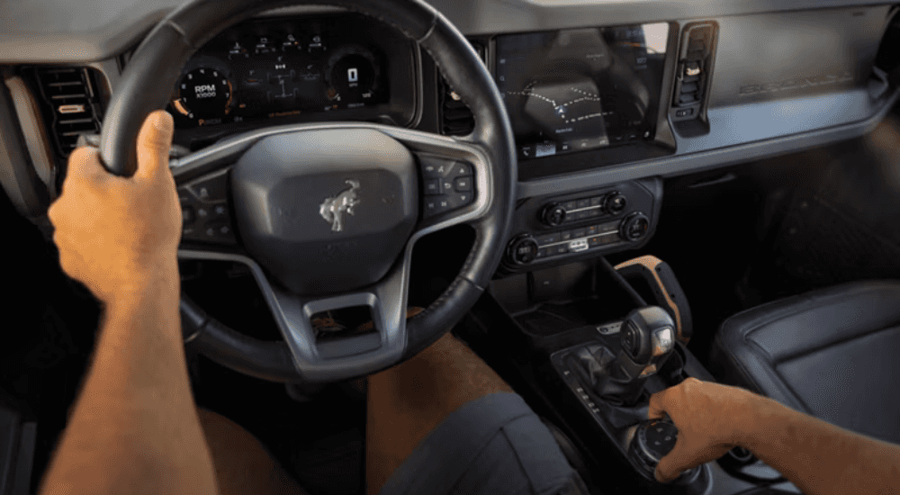 A person sits in a 2026 Ford Bronco at a ford dealer near Amelia