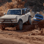 Two 2026 Ford Broncos driving off-road on a trail