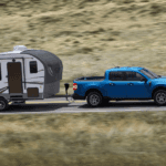 Blue Ford Maverick XLT towing a camper