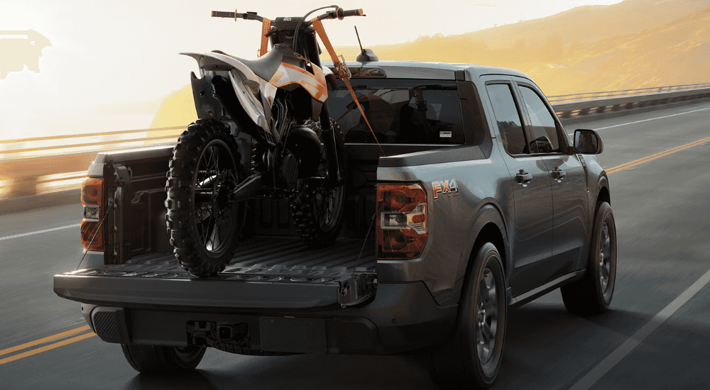 Grey 2025 Ford Maverick XLT FX4 hauling a dirt bike