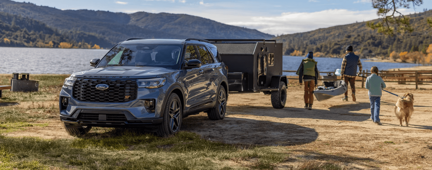 Silver 2026 Ford Explorer towing a camper