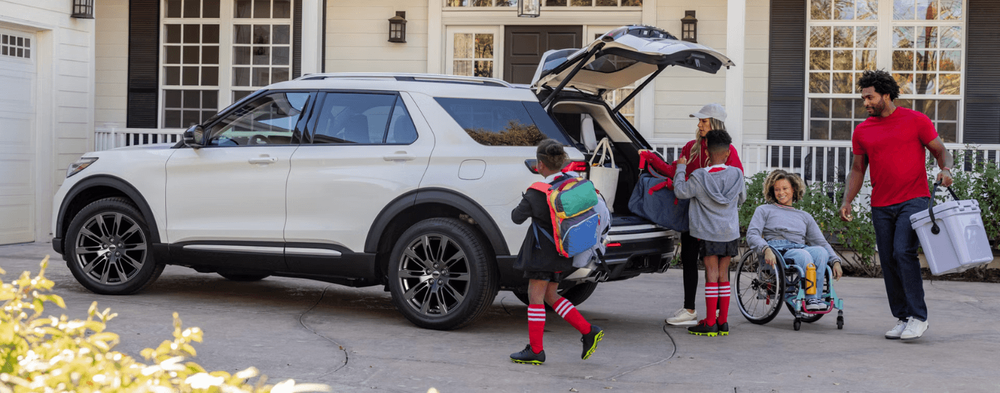 A family packing into a white 2026 Ford Explorer