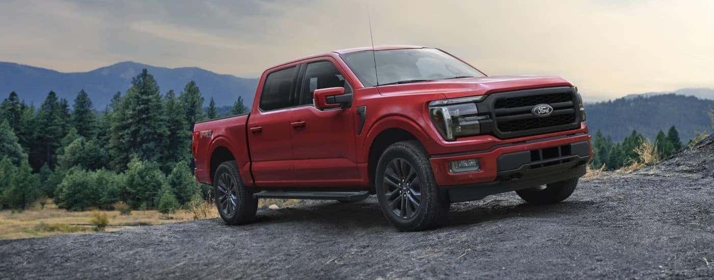 Red 2025 Ford F-150 Lariat for sale near Amelia parked off-road.