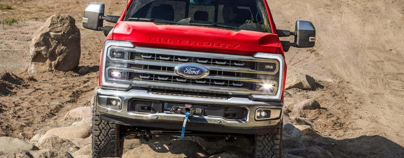 A red 2026 Ford Super Duty off-roading