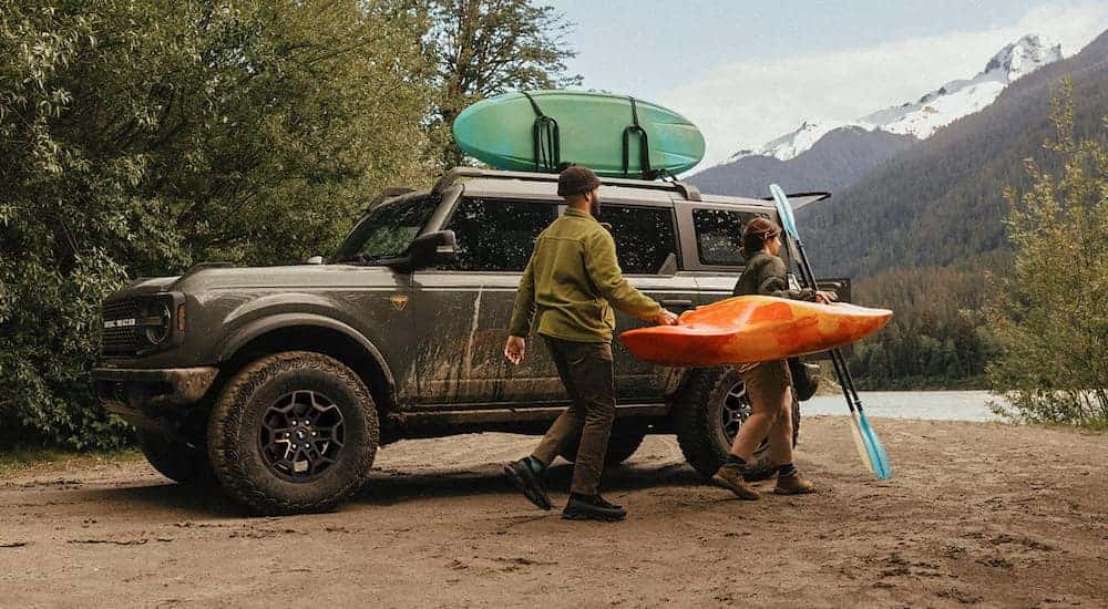 Side of a grey 2026 Ford Bronco parked off-road.