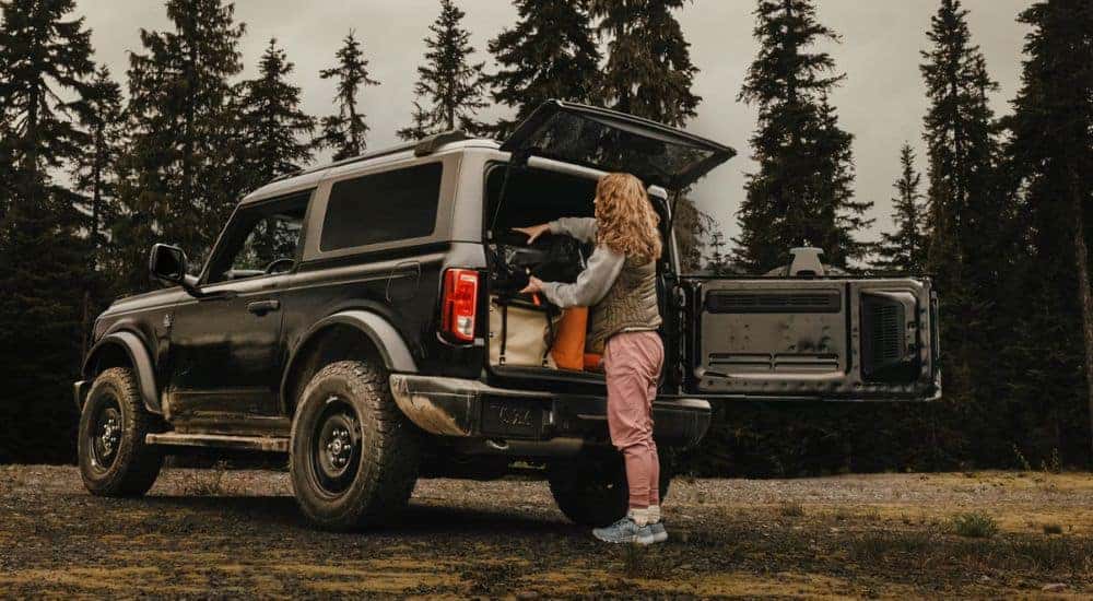 The trunk of a Black 2026 Ford Bronco being loaded by a woman