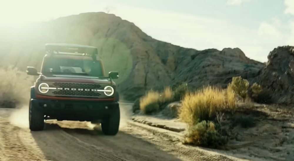 Red 2026 Ford Bronco driving through the desert