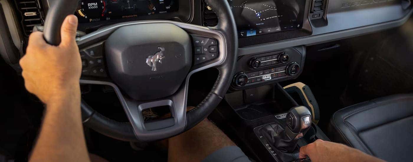 A man driving a 2026 Ford Bronco