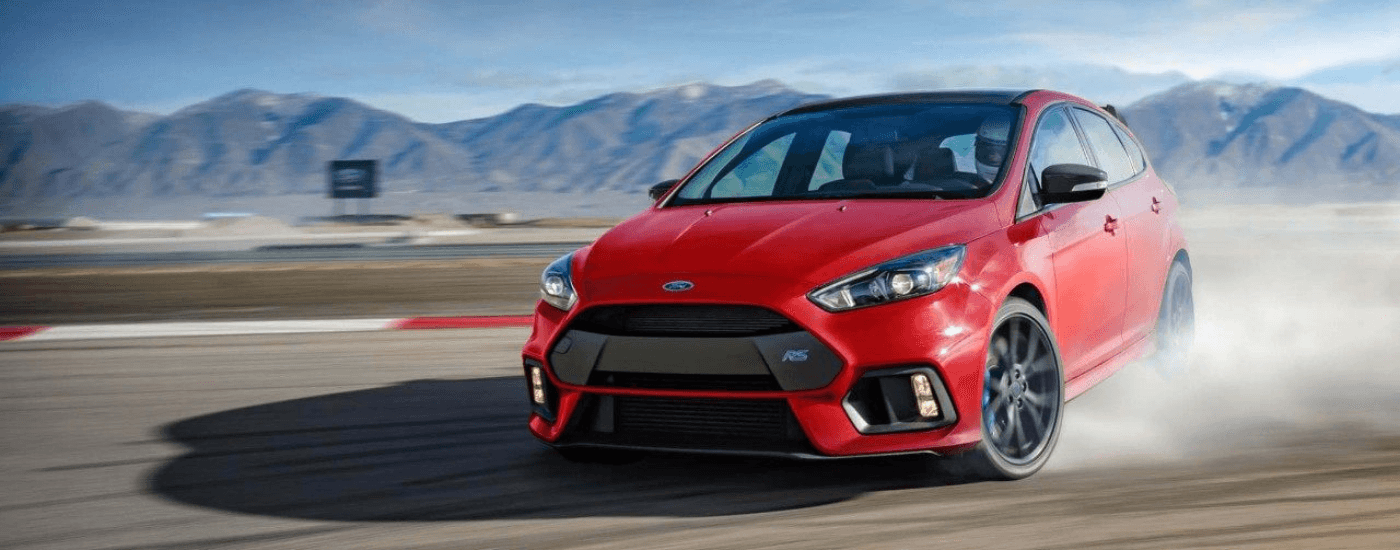 Red 2018 Ford Focus drifting.