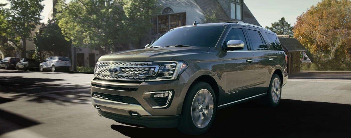 Gold 2020 Ford Expedition Platinum parked in a driveway.