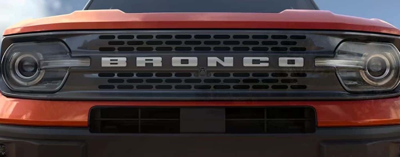 A close up shows the grille on an orange 2023 Ford Bronco Sport Badlands.