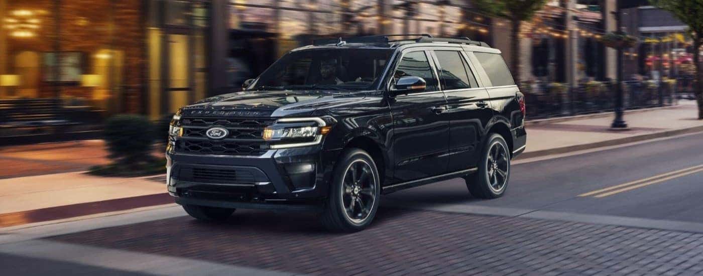 A black 2023 Ford Expedition Stealth Edition parked at a crosswalk.
