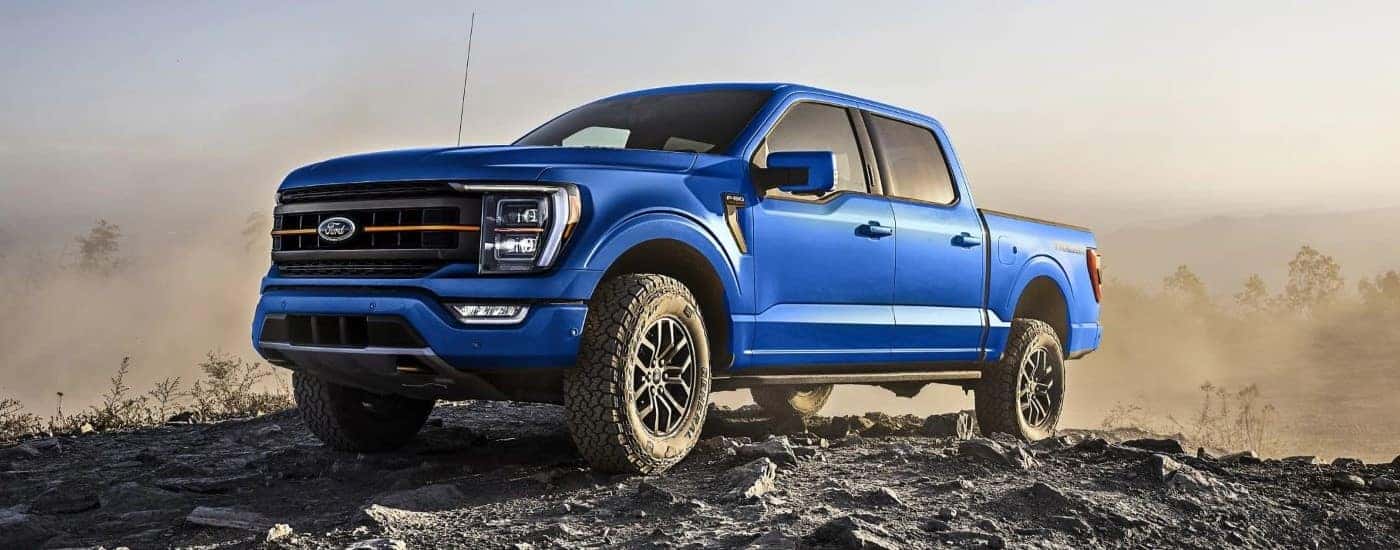 A blue 2023 Ford F-150 Tremor shown parked on rocks.