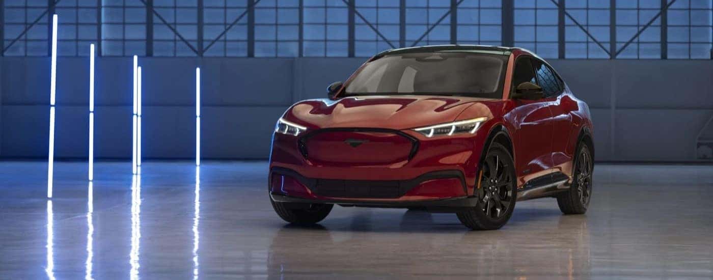 A red 2023 Ford Mustang Mach-E is shown at an angle.