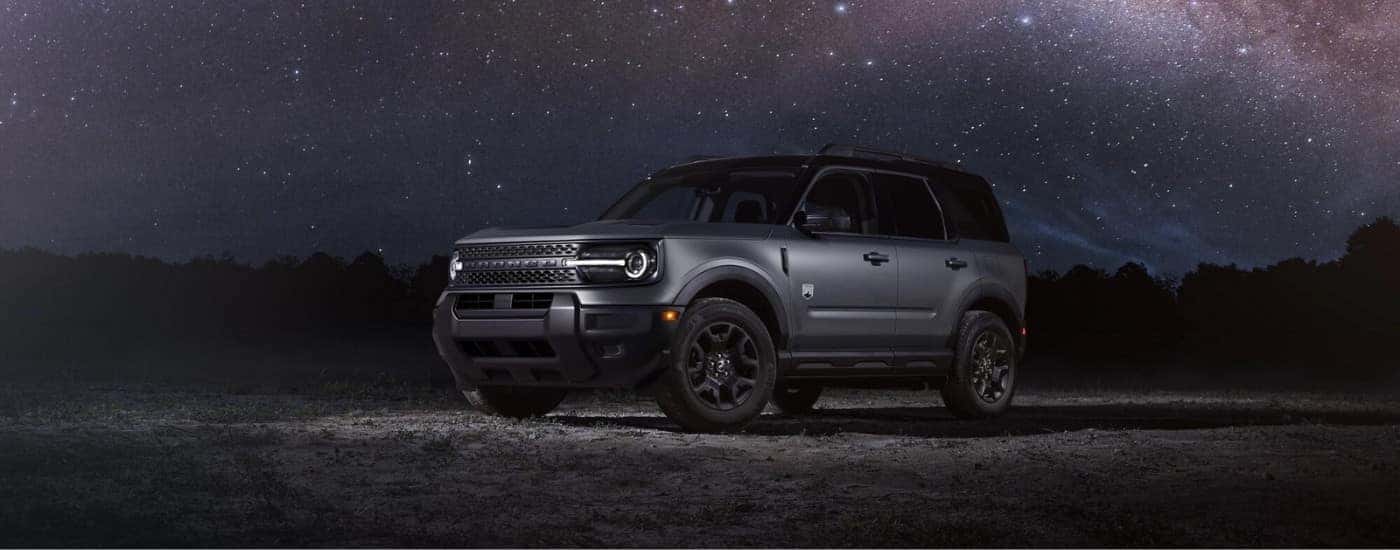 A gray 2025 Ford Bronco Sport Big Bend parked under a starry sky.