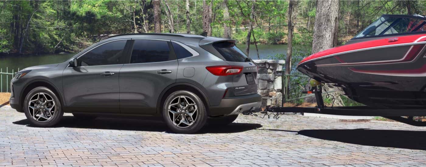 Grey 2026 Ford Escape towing a boat.