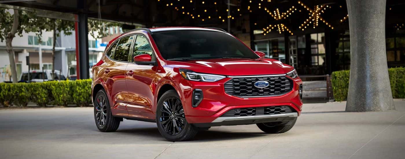 Red 2026 Ford Escape parked in front of a store.
