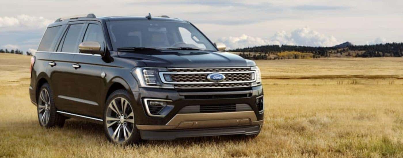 A black 2021 Ford Expedition King Ranch is shown parked in a field.