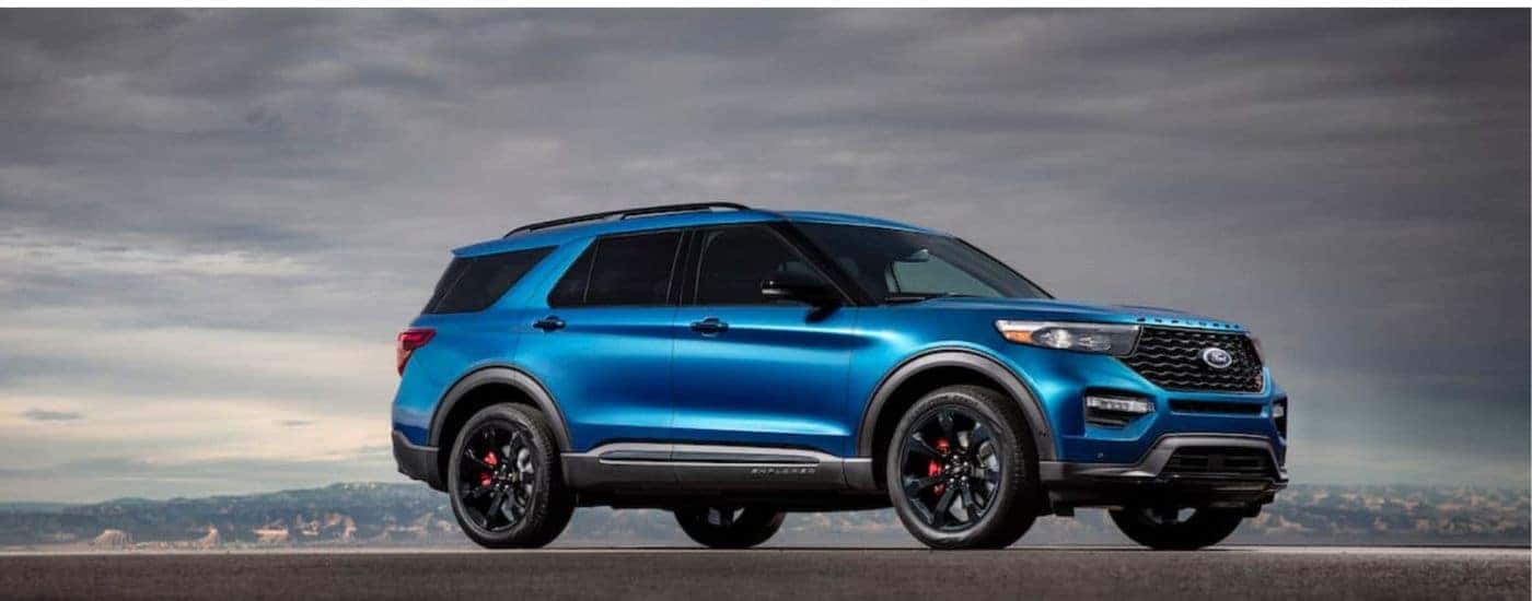 A blue 2020 Ford Explorer ST shown parked under a cloudy sky.