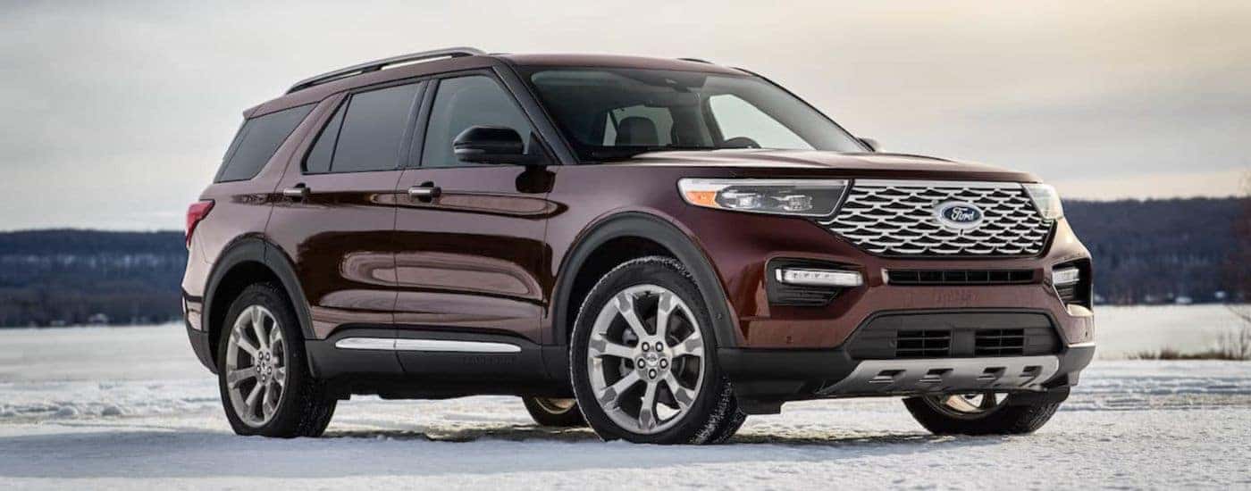 A maroon 2020 Ford Explorer is parked on a snowy field.