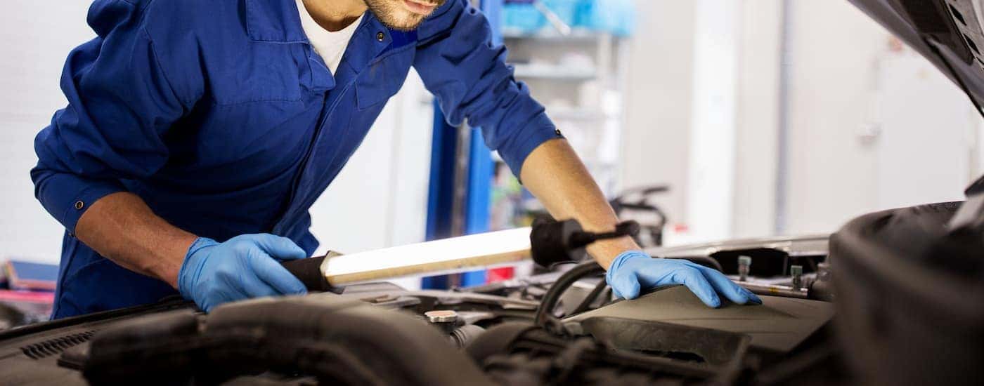 A mechanic inspecting a vehicle.