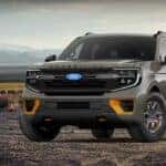 A green 2026 Ford Expedition Tremor is shown parked on a dirt field.
