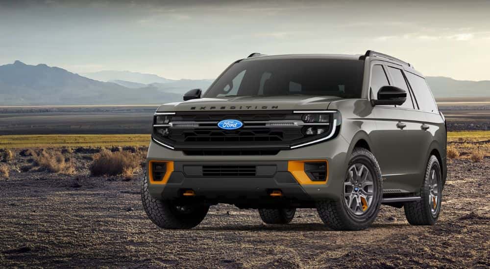 A green 2026 Ford Expedition Tremor is shown parked on a dirt field.