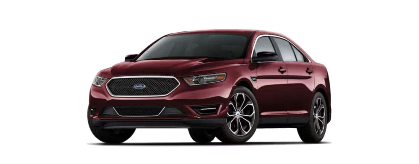 A red 2019 Ford Taurus angled left on a white background.