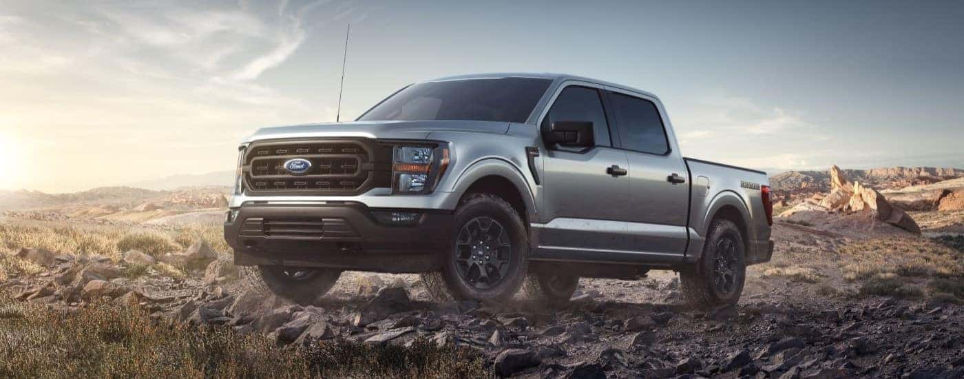 A silver 2023 Ford F-150 Rattler parked off-road.
