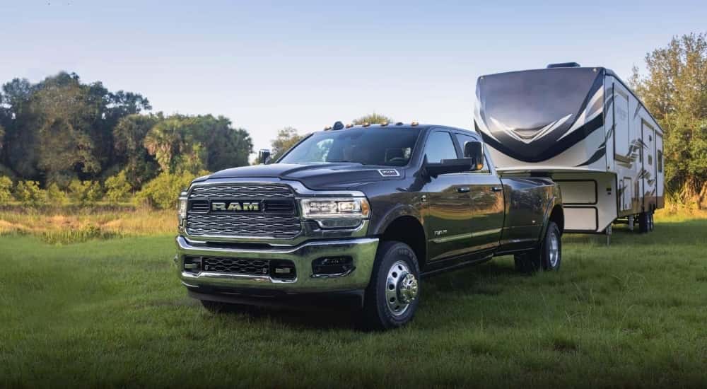 A gray 2022 Ram 3500 towing a camper.