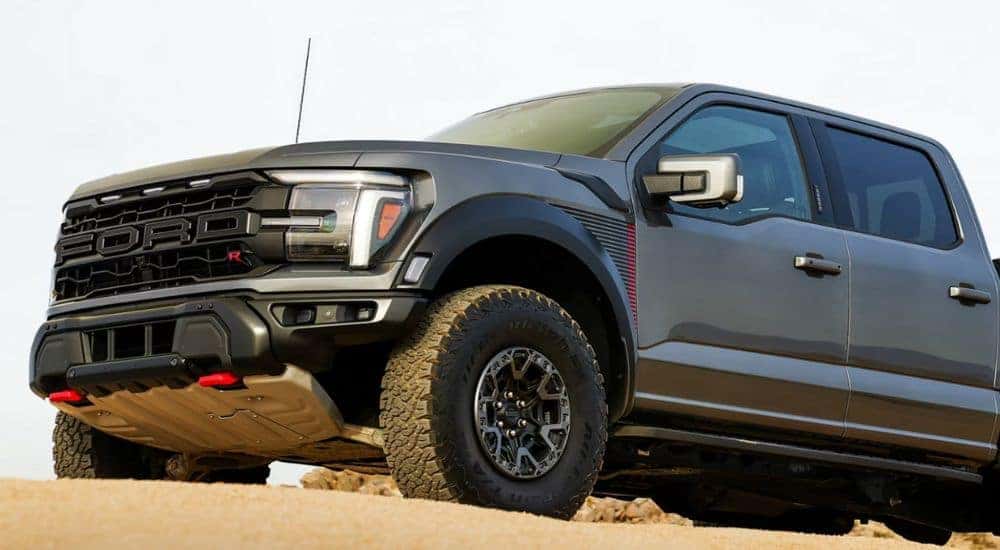 A gray 2026 Ford F-150 Raptor front-end shown parked in desert.