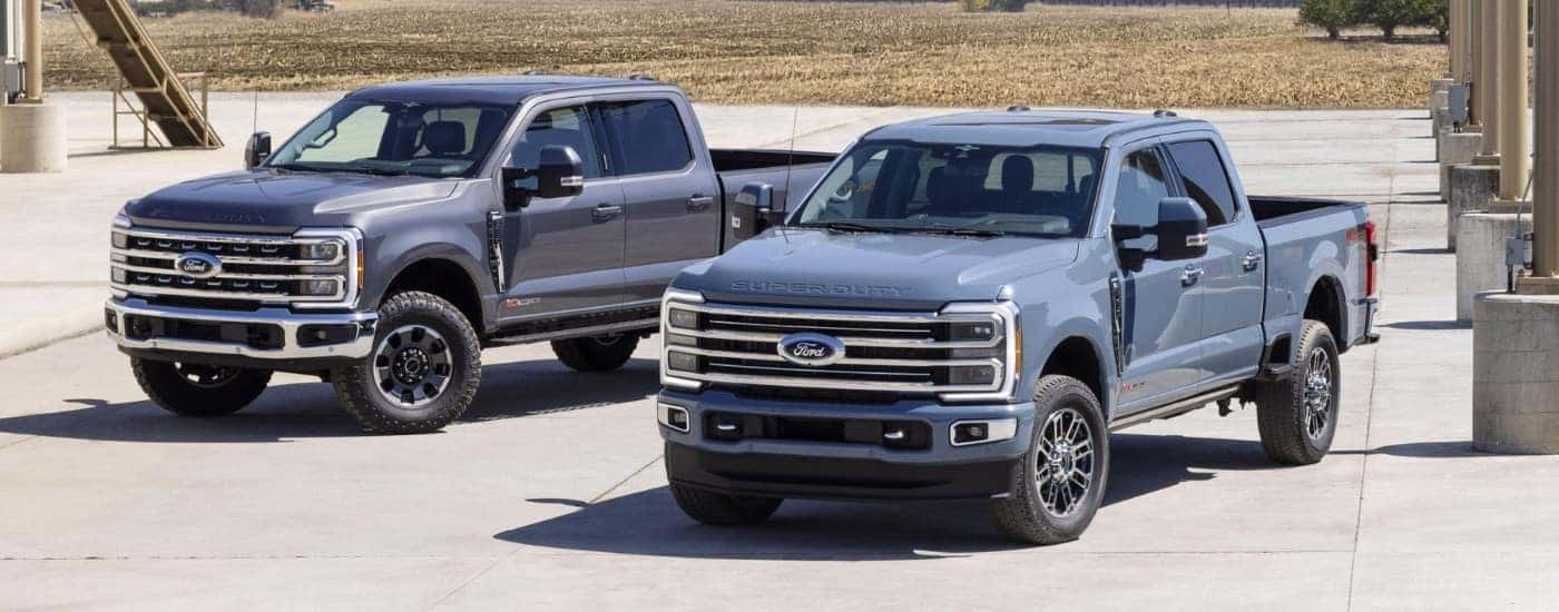 A gray and a blue 2023 Ford F-250 Tremor & F-350 parked side-by-side.