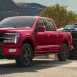 A red 2026 Ford F-150 towing a boat.