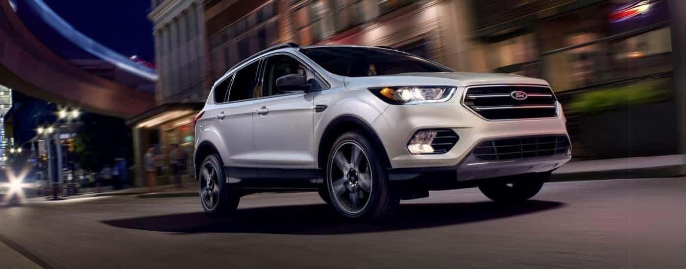 White 2019 Ford Escape driving down a road.