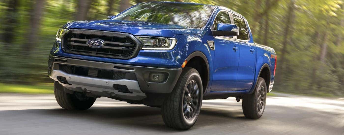 Blue 2021 Ford Ranger FX4 driving down a road.