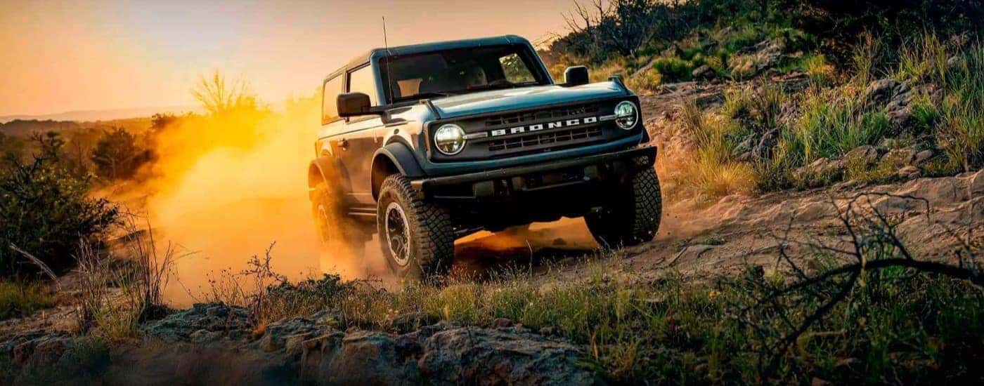 Blue 2022 Ford Bronco driving off-road.
