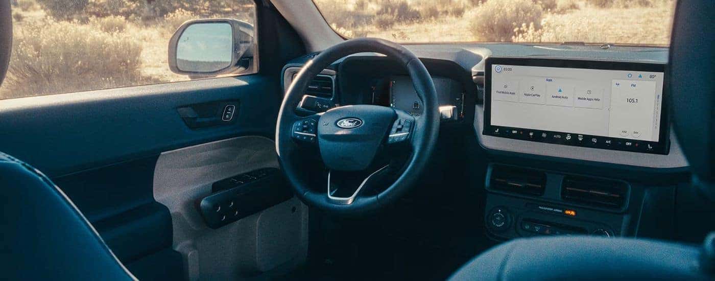 Interior view of a 2026 Ford Maverick infotainment display and steering wheel.