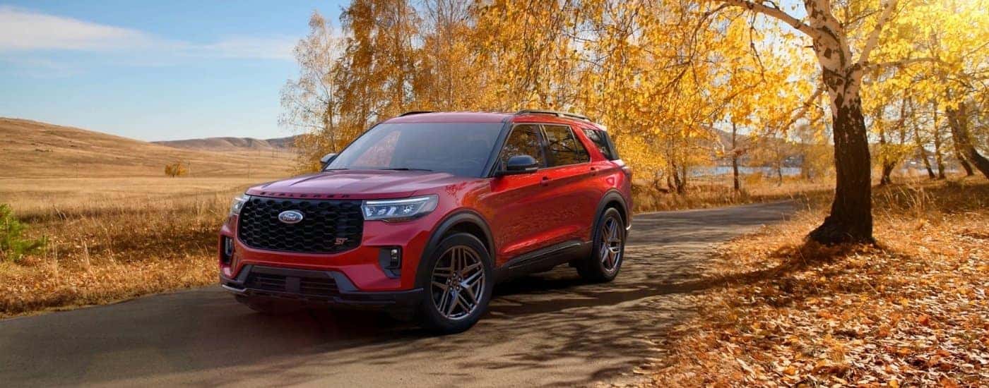 Red 2026 Ford Explorer ST parked under a tree